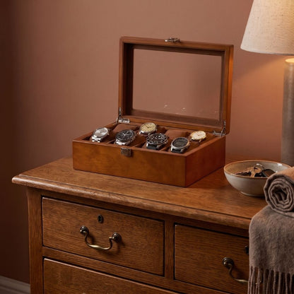 Le Comptoir VIII ambre posé sur une commode en chêne, à côté d'une coupelle et d'un plaid. La boîte à montre est ouverte et comporte 6 montres