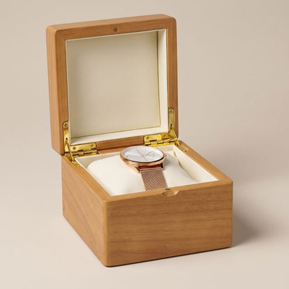 Boîte à montre L'Aubier en bois massif ouverte, intérieur microfibre ivoire avec une montre