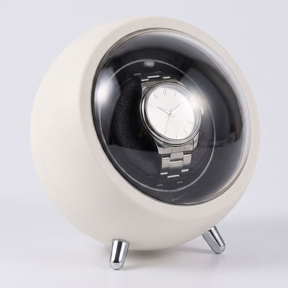 La Capsule, remontoir de montre automatique blanc, capot ouvert avec montre à l'intérieur